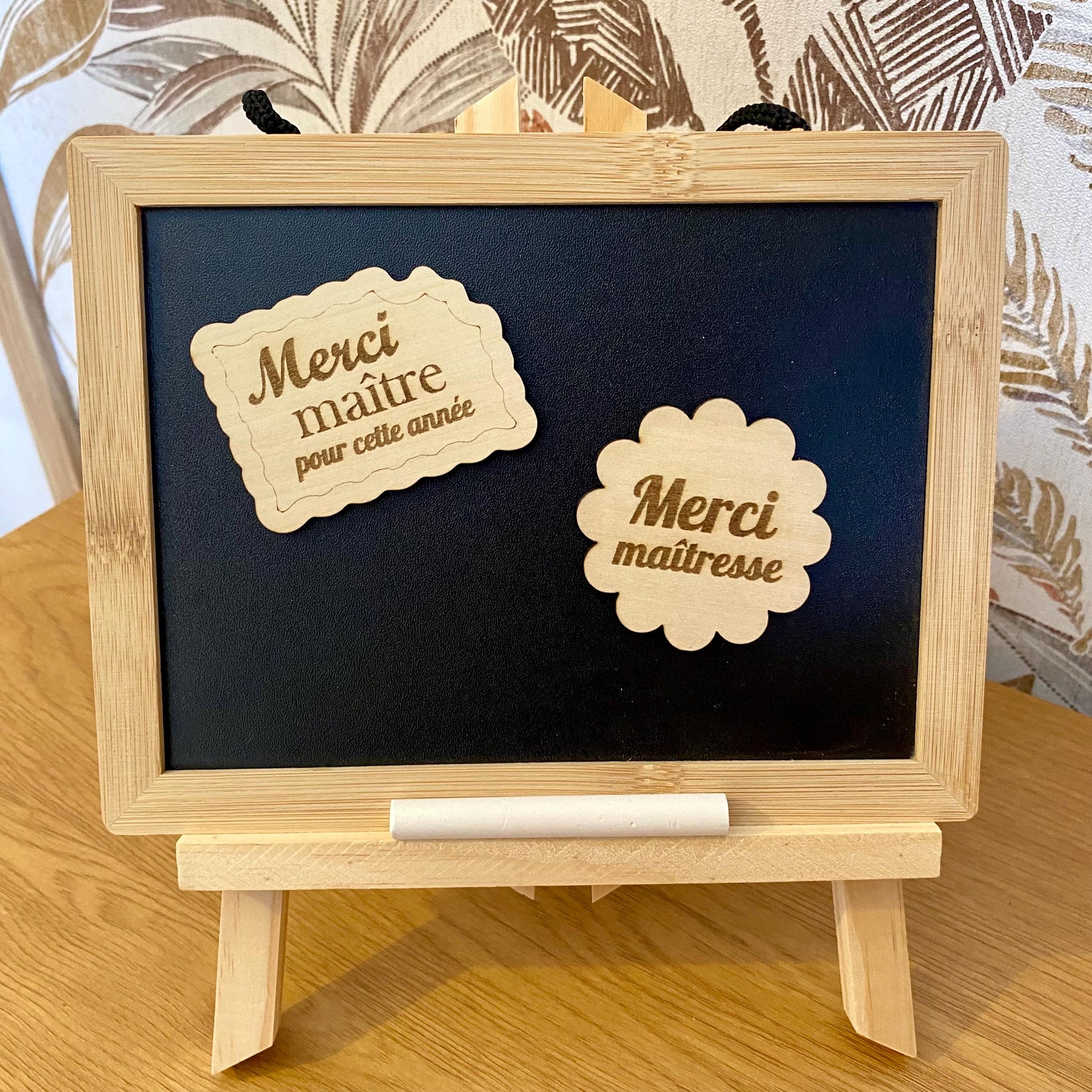 Plusieurs magnets en bois fixés sur la porte d'un réfrigérateur au milieu de photos de famille."