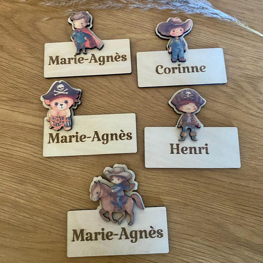 Assortiment de marque-places et magnets en bois sur les thèmes pirate, chevalier et super-héros.
